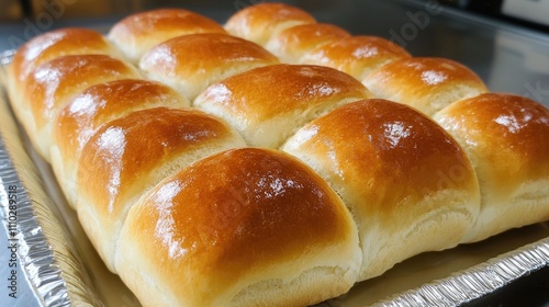 freshly baked golden bread rolls on a tray from the bakery ready for serving photo