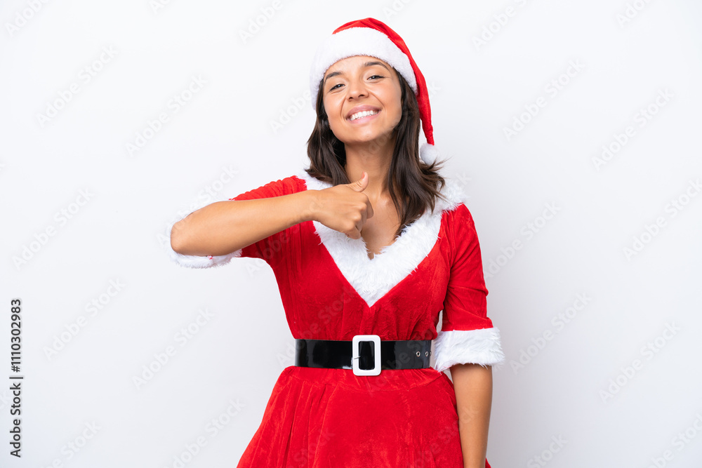 Young hispanic woman dressed as mama noel isolated on white background giving a thumbs up gesture Young hispanic woman dressed as mama noel isolated on white background giving a thumbs up gesture