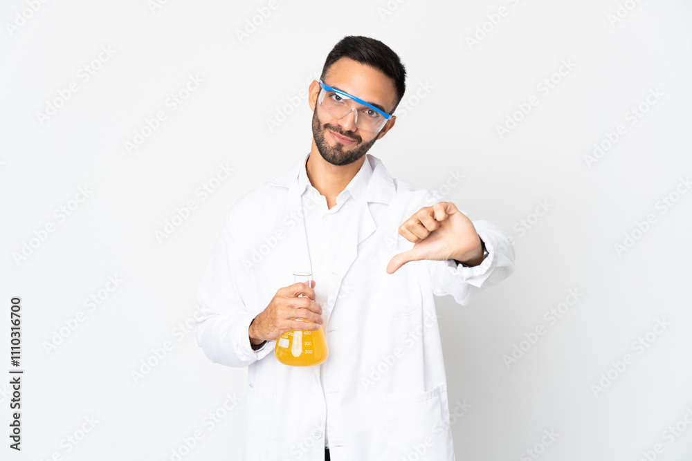Young scientific man isolated on white background showing thumb down with negative expression Young scientific man isolated on white background showing thumb down with negative expression