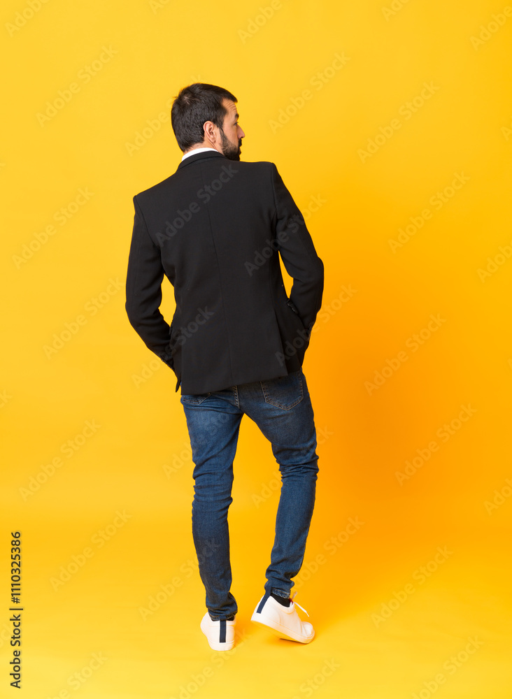 Fototapeta premium Full-length shot of business man over isolated yellow background