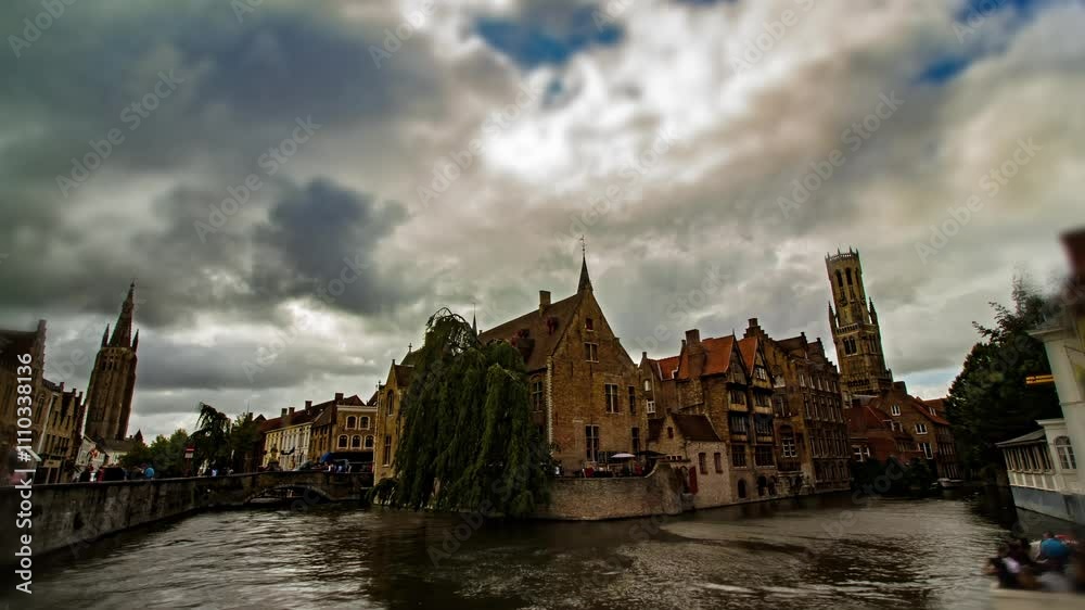 Dramatic sky over Rozendhoedkaai,  iconic spot of Bruges, Belgium. Architecture and culture gems concept. Unesco World Heritage listed city. Europe top destination.