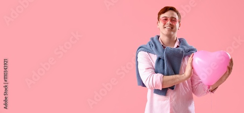 Happy young man holding hea...
