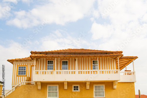 yellow striped house on the coast