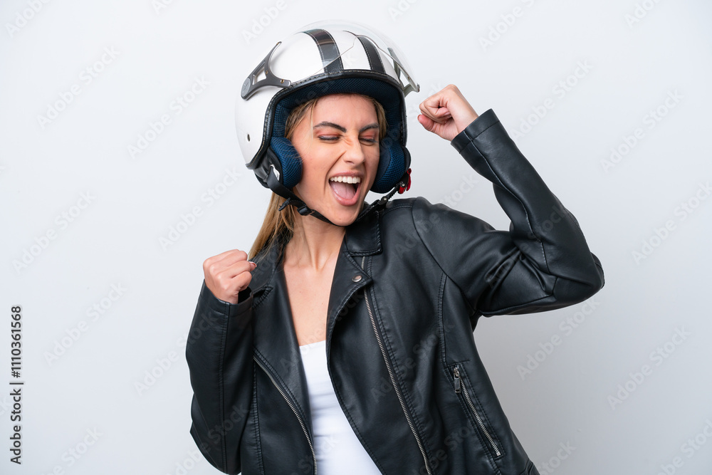 Young caucasian woman with a motorcycle helmet isolated on white background celebrating a victory Young caucasian woman with a motorcycle helmet isolated on white background celebrating a victory
