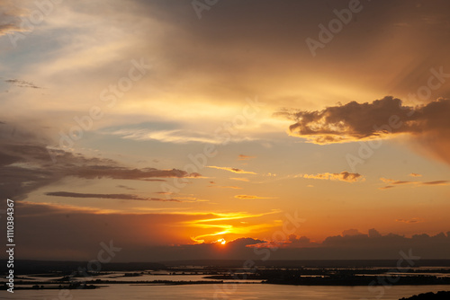 Vibrant colors paint the sky as the sun sets over Sviyazhsk, casting reflections on the calming waters below.