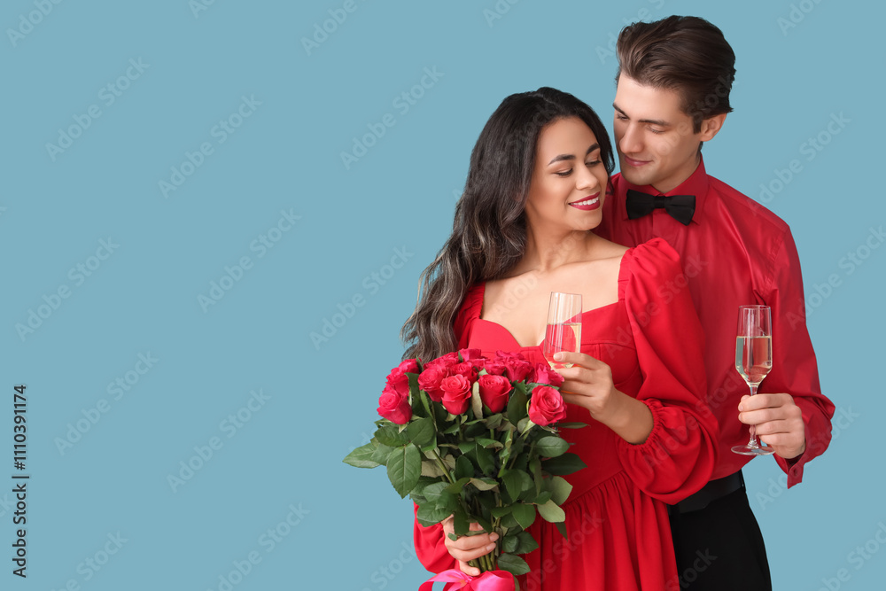 Young couple with champagne and roses on blue background. Valentine's Day celebration Young couple with champagne and roses on blue background. Valentine's Day celebration