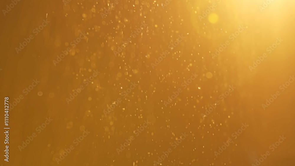 Many sparkling glitters floating in bright light on empty golden background with light from above. Many sparkling glitters floating in bright light on empty golden background with light from above.