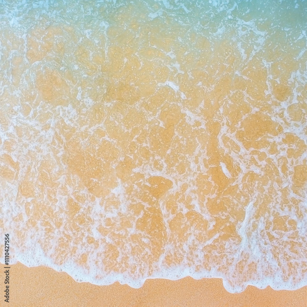 Fototapeta premium Soft ocean waves gently lapping on sandy beach.