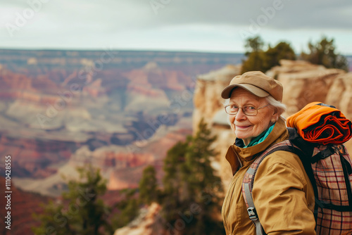 Fototapeta Naklejka Na Ścianę i Meble -  Elderly Caucasian female hiker explores scenic canyon landscape