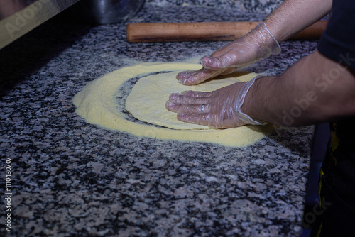 Obraz na płótnie The essence of Italian cuisine captured in a photo: a pizza maker working the dough with passion and precision. w salonie
