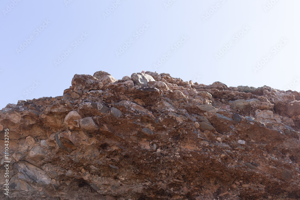 Detailed close-up of the distinct sedimentary layers in a geological formation, located 50 km south of Marrakech, revealing the passage of time through the rock formations.