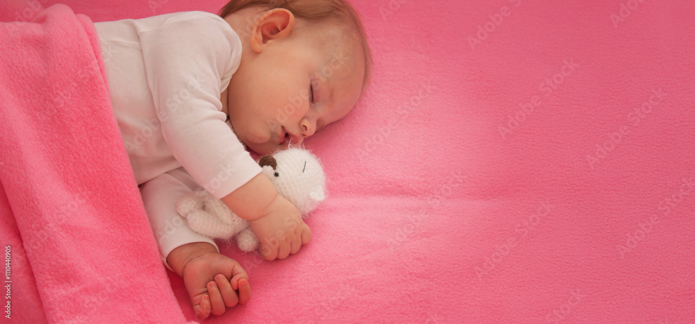 Baby sleeping on a pink background with a pink teddy bear.child Baby sleeping on a pink background with a pink teddy bear.child