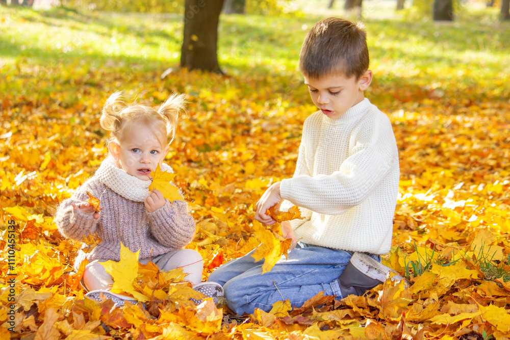 Happy children, boy and little girl in autumn park. Autumn Happy children, boy and little girl in autumn park. Autumn