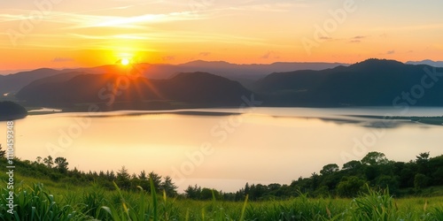A serene background landscape featuring rolling hills, lush forests, and a colorful sunset sky reflected in a calm lake, picturesque, nature, serene