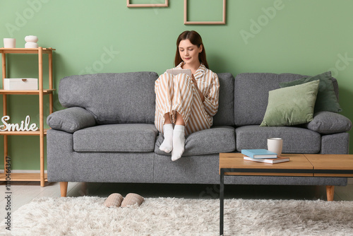 Young woman in pajamas work...