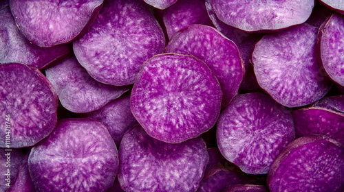 Detailed shot of vivid purple ube yam slices with their rich color contrasting against a clean background