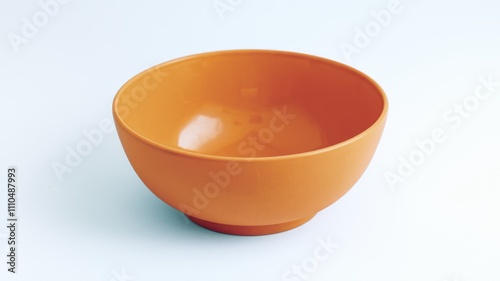 A vibrant orange bowl empty and ready to be filled with delicious food.