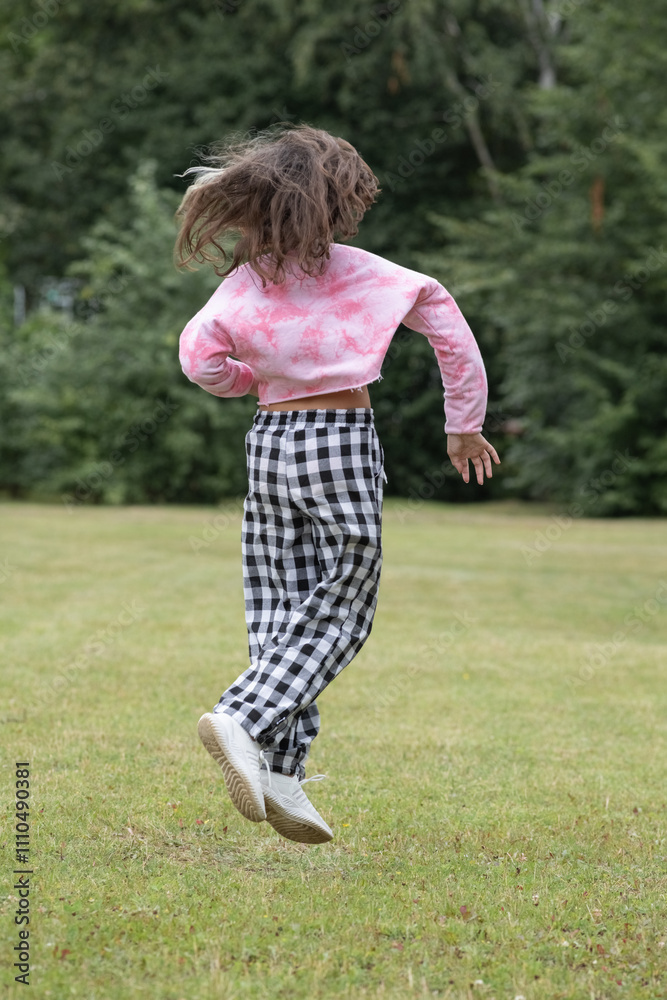 A young beautiful girl frolics in a summer park. A young beautiful girl frolics in a summer park.