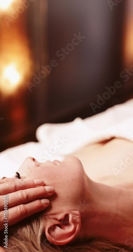Close up of mid adult woman during head and neck massage - vertical video
