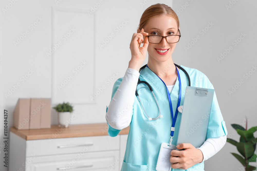 Happy female doctor with stethoscope and clipboard in clinic Happy female doctor with stethoscope and clipboard in clinic