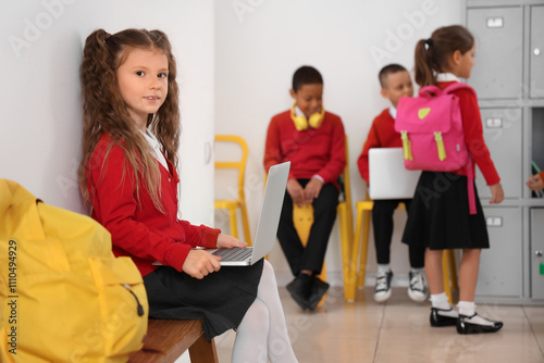Little schoolgirl with lapt...