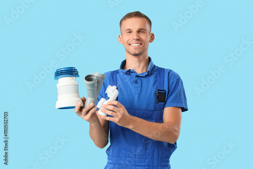 Male plumber with pipes on ...