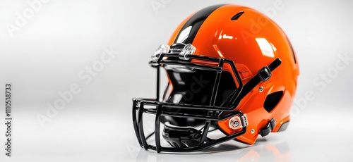 Cleveland Browns football helmet, vibrant orange and black design, modern protective gear, sleek finish, sports equipment, copy space for text photo