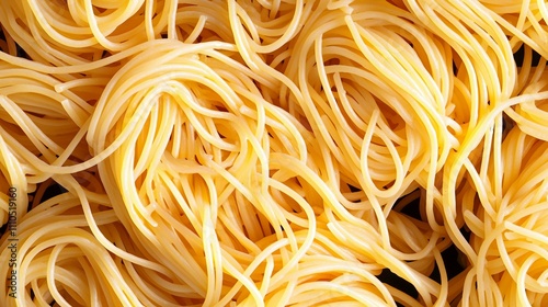 Raw spaghetti noodles on a dark background, top view image