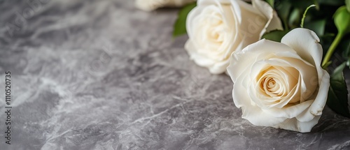 White roses bouquet on a grey background with bokeh and copy space