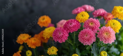 Colorful flowers arrangement with pink, yellow, orange blooms, vibrant display, green leaves, soft focus background, copy space for text