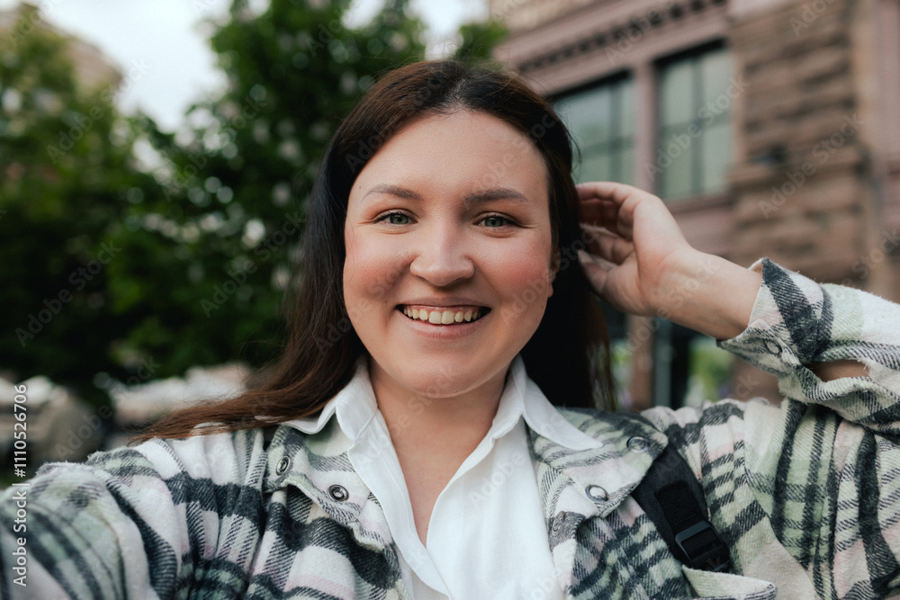 Vlogger traveler woman recording video on phone camera share via app her travel vacation in the city. Gen Z Plus size girl influencer shooting social media stories on the street Vlogger traveler woman recording video on phone camera share via app her travel vacation in the city. Gen Z Plus size girl influencer shooting social media stories on the street