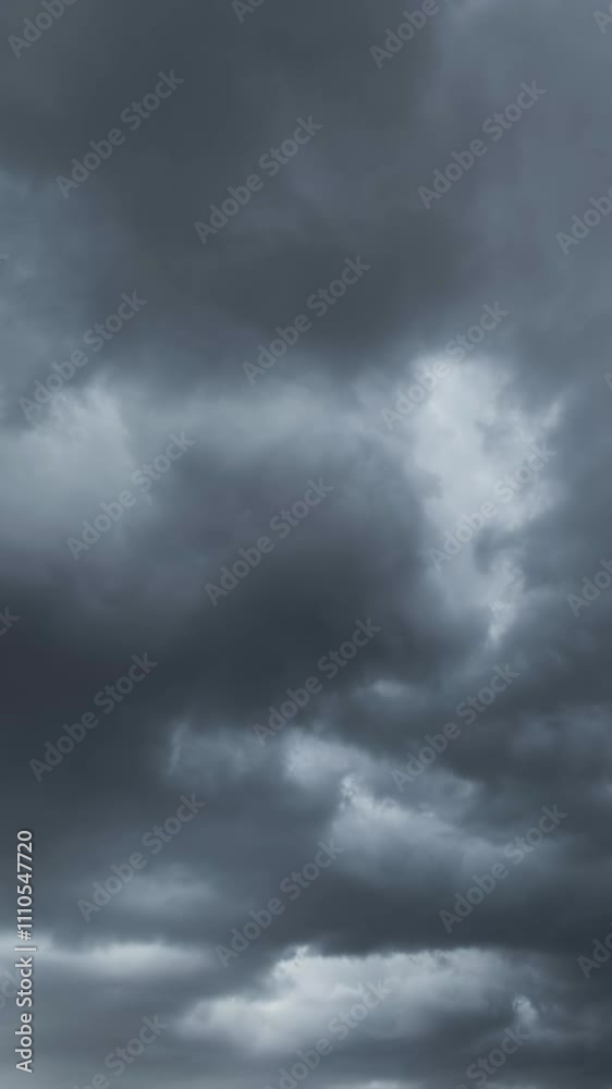 Dramatic dark storm clouds are moving fast. Vertical video Dramatic dark storm clouds are moving fast. Vertical video