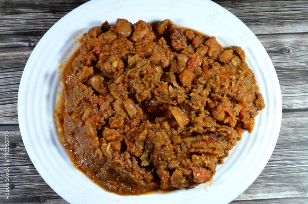 Egyptian fava beans with beef meat sausage, the main dish, sandwich in the breakfast in Egypt, cooked with crushed bean, yellow lentils and wheat, Fava beans main dish of Suhor in Ramadan Egyptian fava beans with beef meat sausage, the main dish, sandwich in the breakfast in Egypt, cooked with crushed bean, yellow lentils and wheat, Fava beans main dish of Suhor in Ramadan