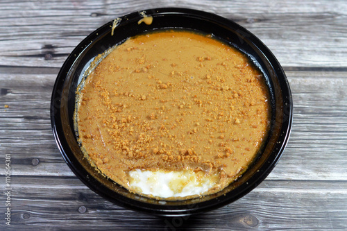 Rice pudding topped with Biscuits butter spread and pieces,  also called Riz au lait, Sütlaç, Sholezard and moghli topped with biscuit pieces and made of rice, milk or water, corn flour and sugar photo