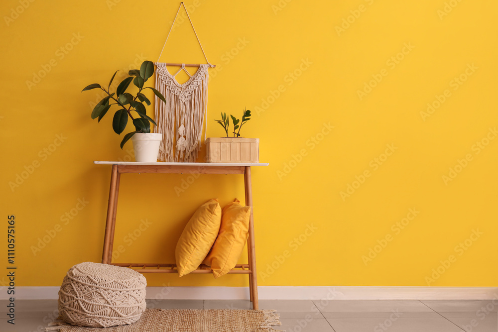 © Pixel-Shot - Table with plants, pillows and pouf near yellow wall in room © Pixel-Shot - Table with plants, pillows and pouf near yellow wall in room