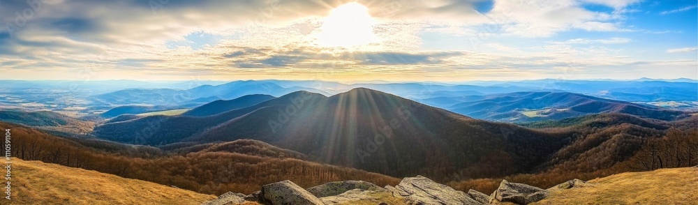 Obraz premium Panoramic view of Carpathian Mountains with sun rays, rolling hills, and majestic peaks under a blue sky.