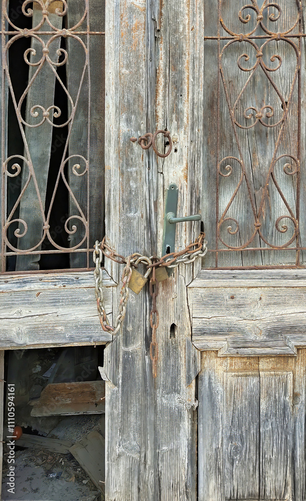 Old Wooden Door Locked With Chain And Rusty Padlock Old Wooden Door Locked With Chain And Rusty Padlock