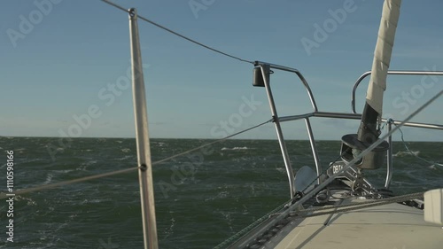 Sailboat running with the Wind in strong Winds and choppy waves