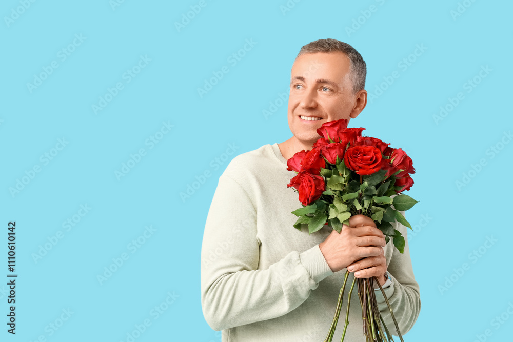 Happy mature man with bouquet of rose flowers on blue background. Valentine's day celebration Happy mature man with bouquet of rose flowers on blue background. Valentine's day celebration