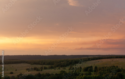 Vibrant sunset illuminates the rolling hills of Sviyazhsk, creating a serene atmosphere filled with golden colors.