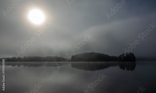 Misty morning at a lake during sunrise photo