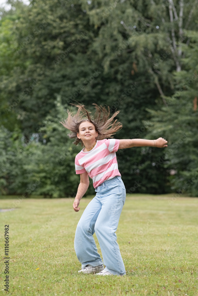 A young beautiful girl frolics in a summer park. A young beautiful girl frolics in a summer park.