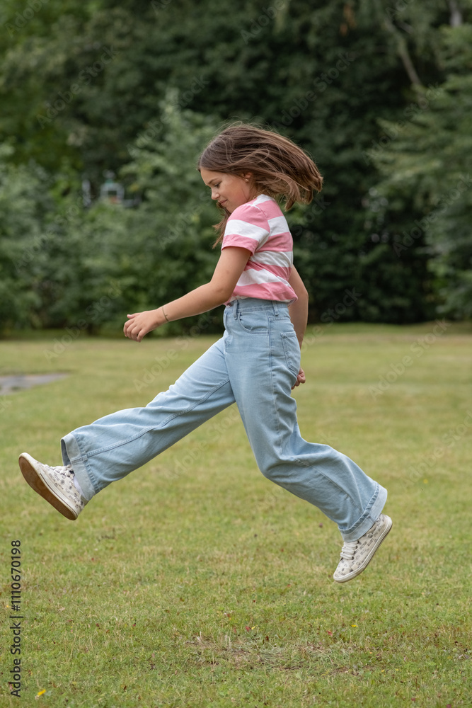 A young beautiful girl frolics in a summer park. A young beautiful girl frolics in a summer park.