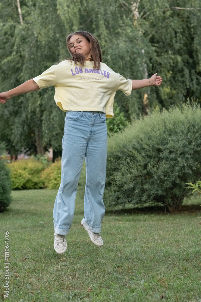 A young beautiful girl frolics in a summer park. A young beautiful girl frolics in a summer park.