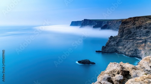 High cliffs on the seashore, covered with a light haze of fog, create an atmosphere of mystery and grandeur peculiar to nature. 