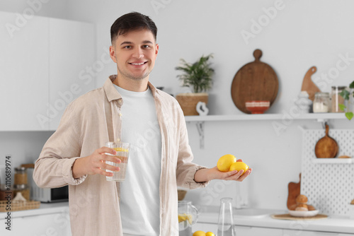 Young man with glass of wat...