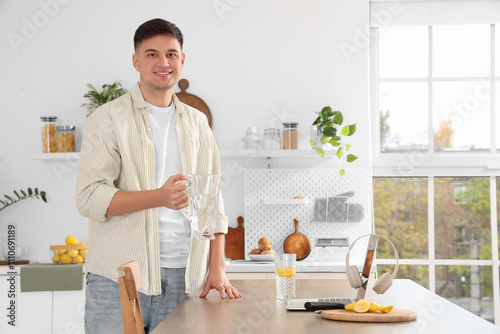 Young man with jug and glas...