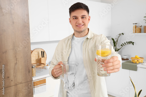 Young man with jug and glas...