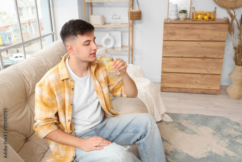 Young man with glass of lem...