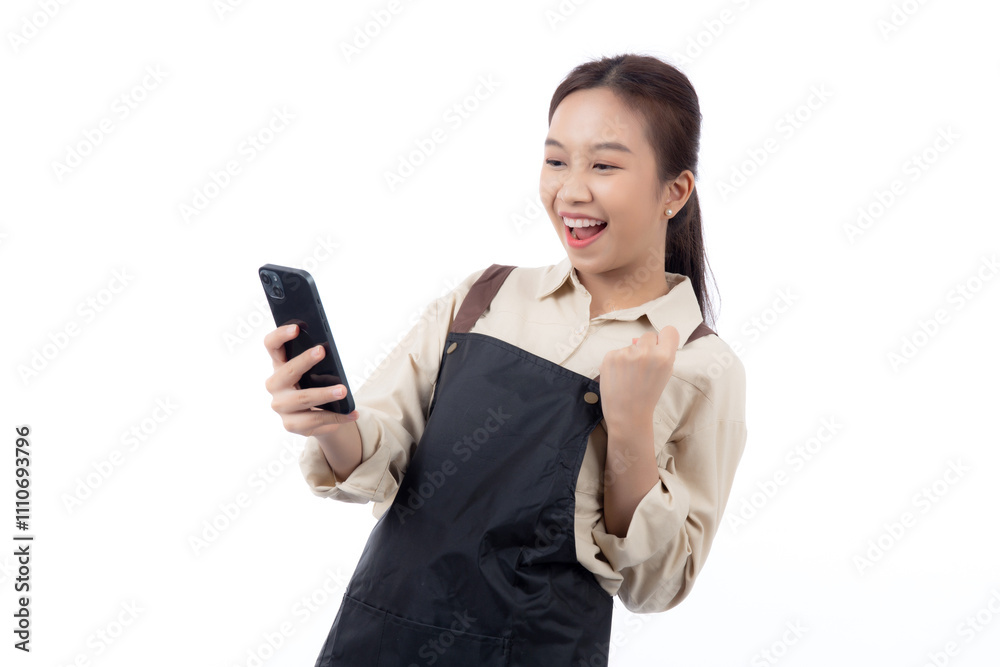 Portrait happy young asian barista woman in apron while looking smart phone gesture success isolated white background, waitress or entrepreneur watching smartphone, small business or startup. Portrait happy young asian barista woman in apron while looking smart phone gesture success isolated white background, waitress or entrepreneur watching smartphone, small business or startup.